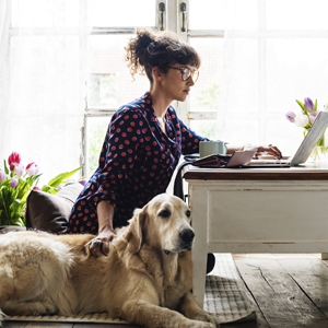 Woman working from home with her dog